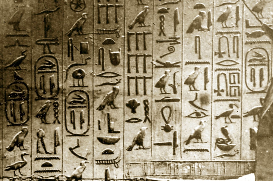 Egyptian hieroglyphs carved into a stone wall